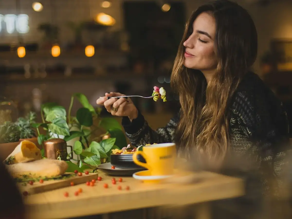A guest enjoying a meal in a warmly lit restaurant