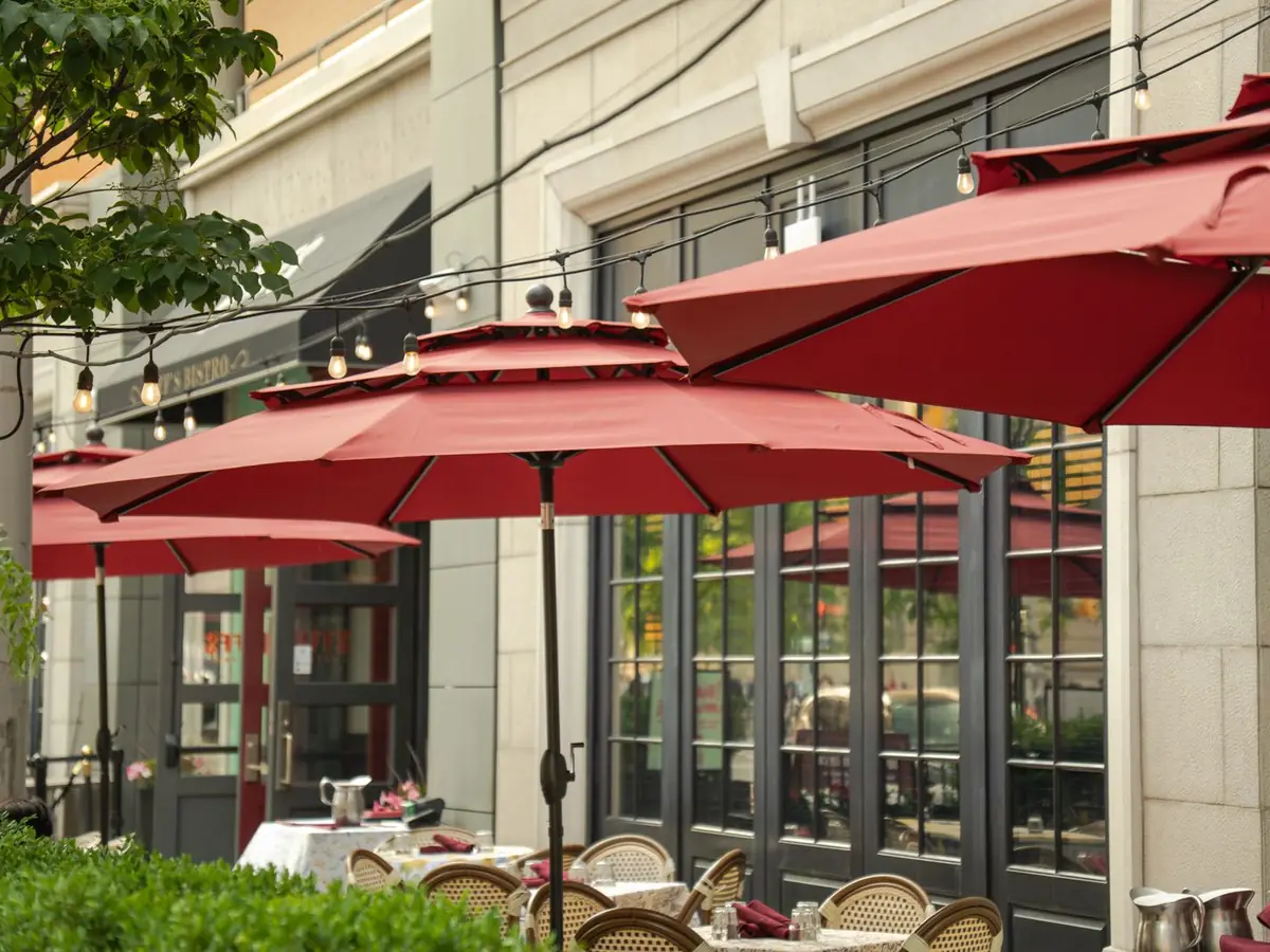 A restaurant patio with red umbrellas in downtown Toronto